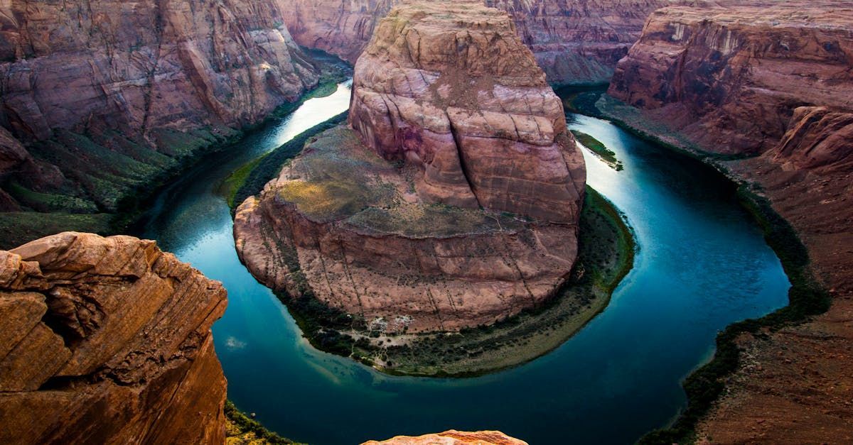 A large body of water surrounded by rocks in a canyon.