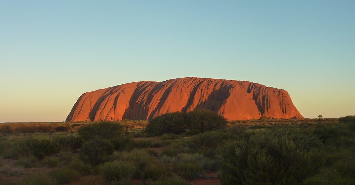 A large rock formation in the middle of a desert.