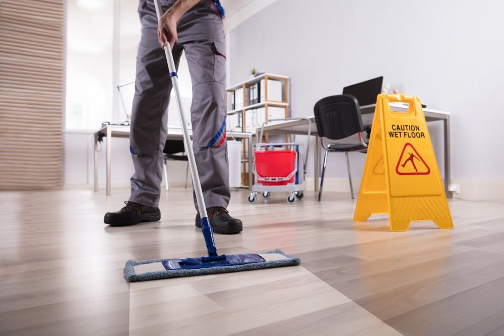 Person Sweeping Floor — Professional Cleaning Company in Pialba, QLD
