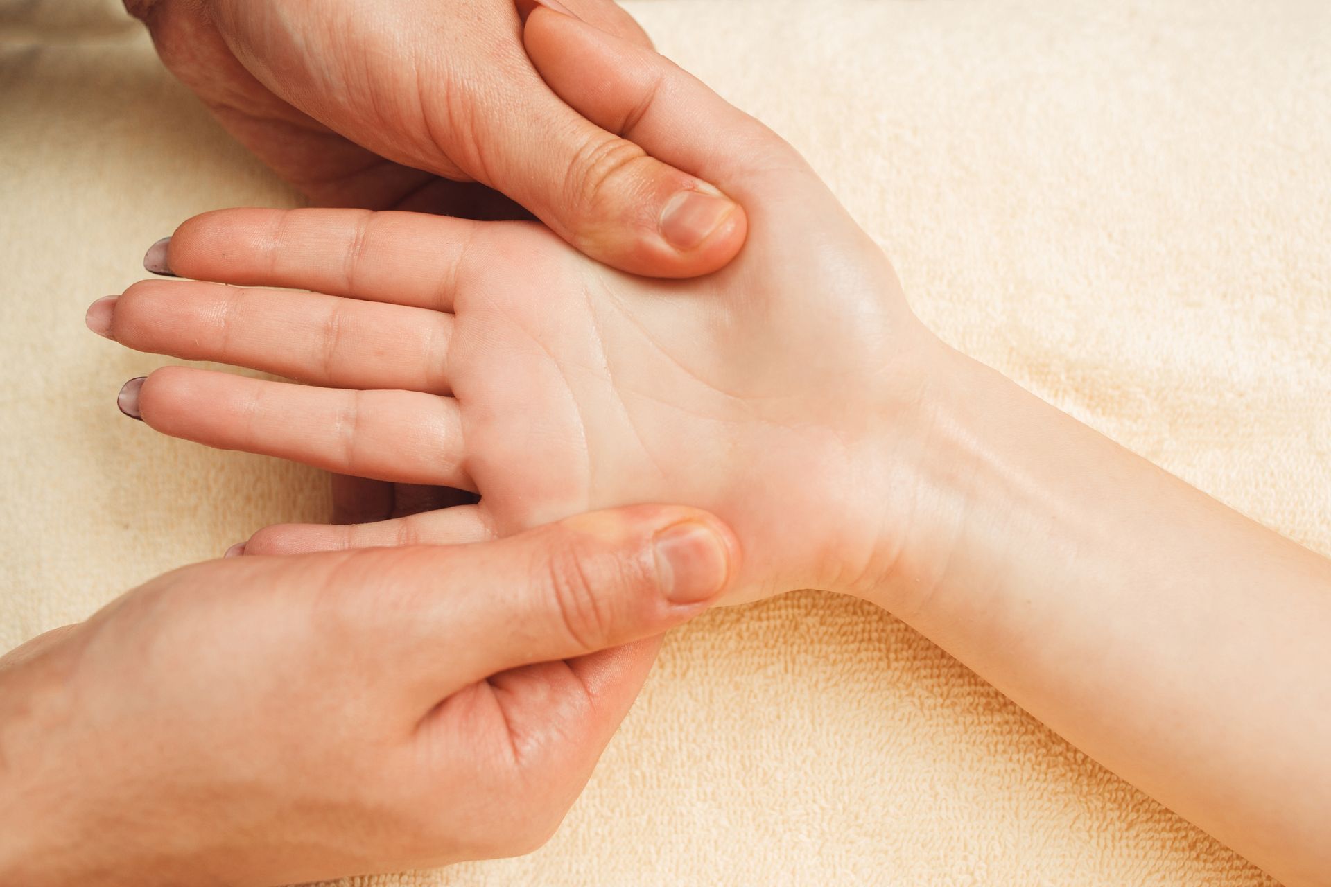 A person is giving a hand massage to another person.