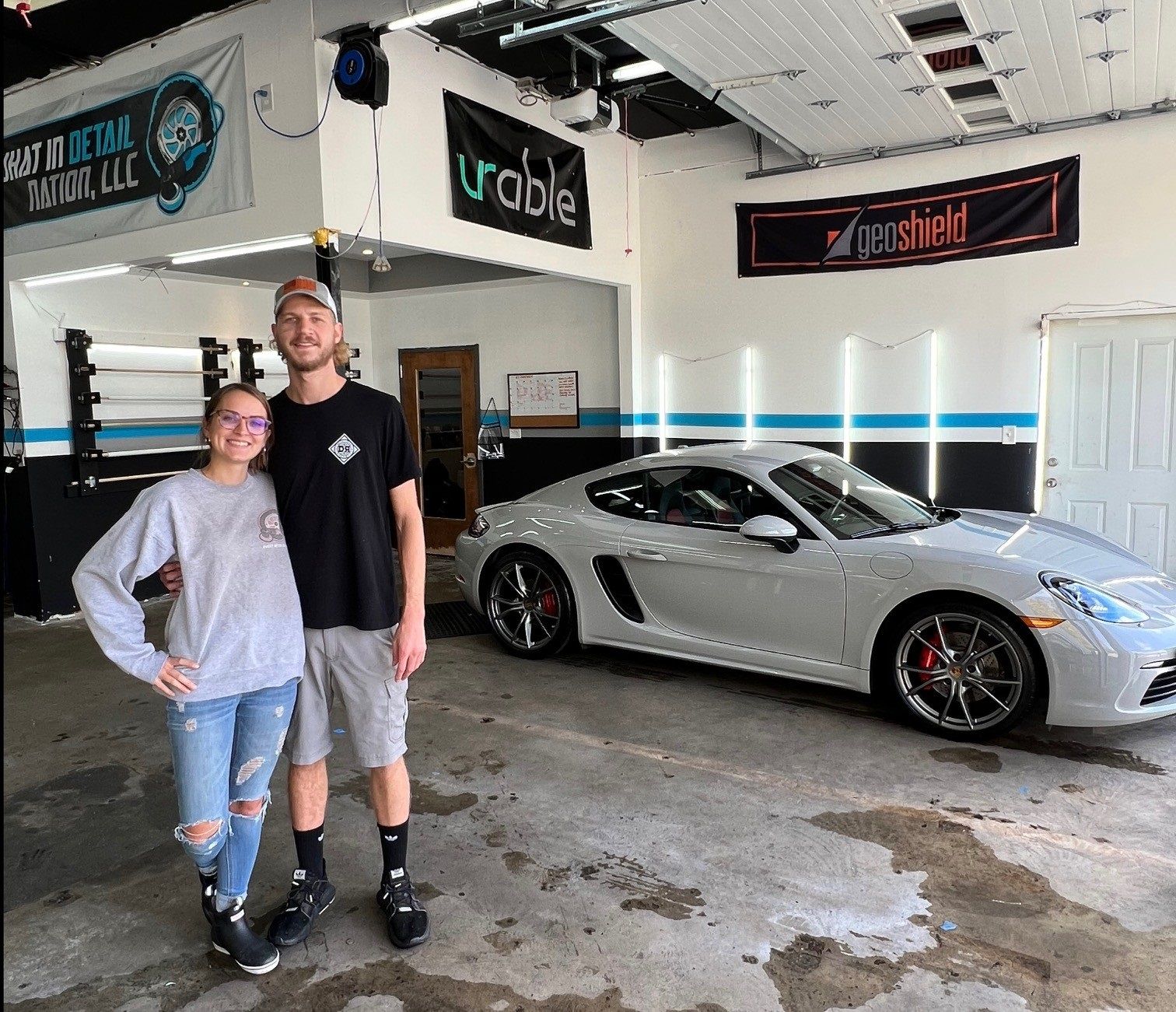 Husband and wife ceramic coating specialists working on Porsche in Westminster MD