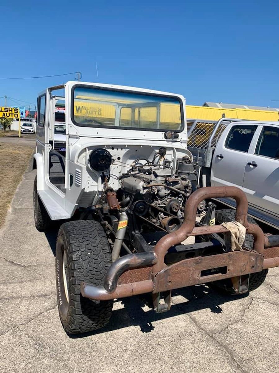 A White Jeep Is Parked On The Side Of The Road — Hannam Street Mufflers and Mechanical In Bungalow, QLD