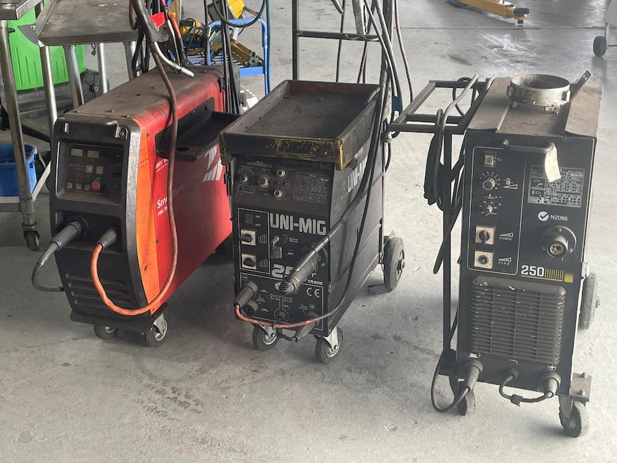 Three Welding Machines Are Sitting On A Cart In A Garage — Hannam Street Mufflers and Mechanical In Bungalow, QLD