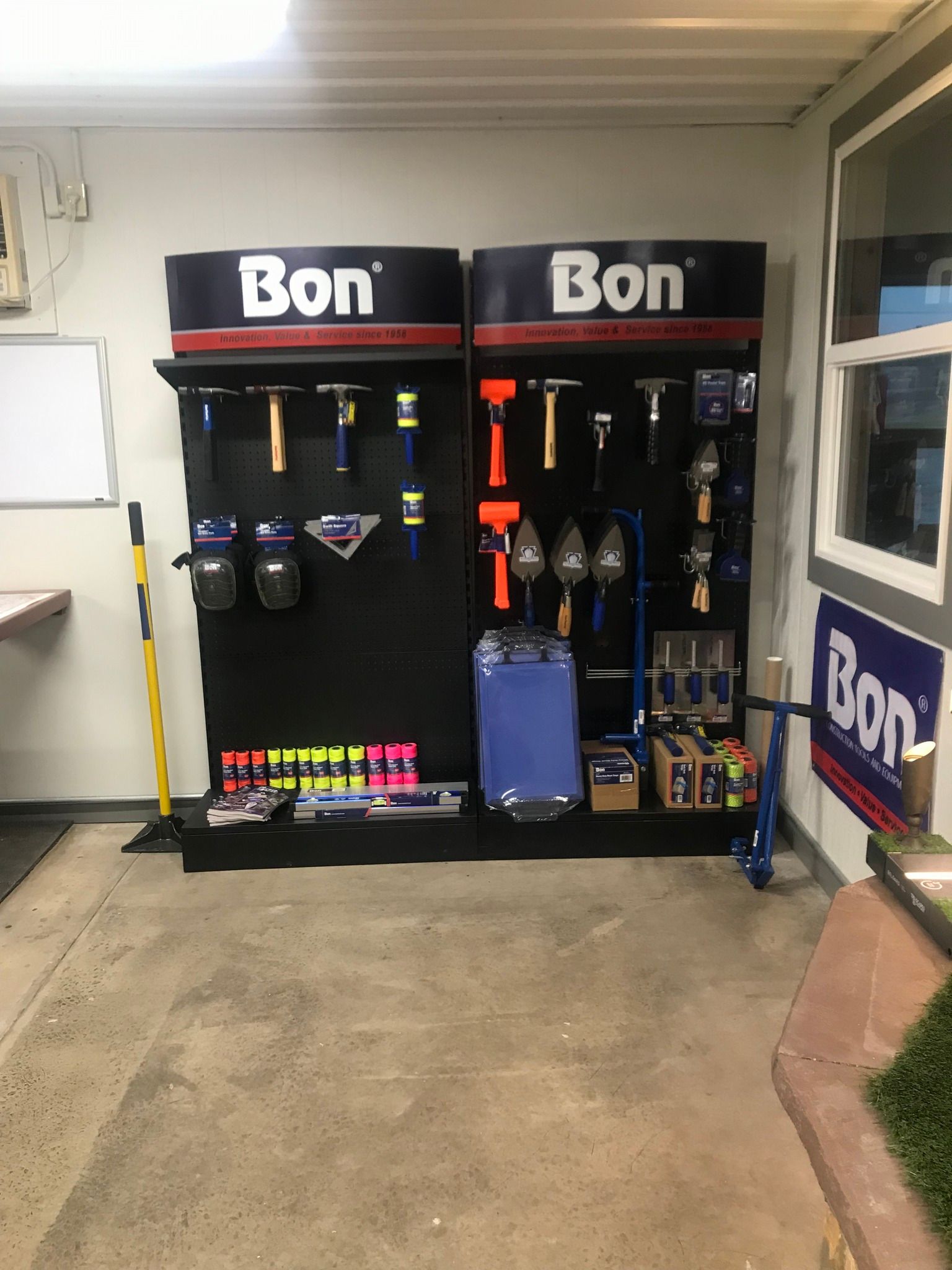 Bon display with tools and accessories on racks in a garage-like indoor space