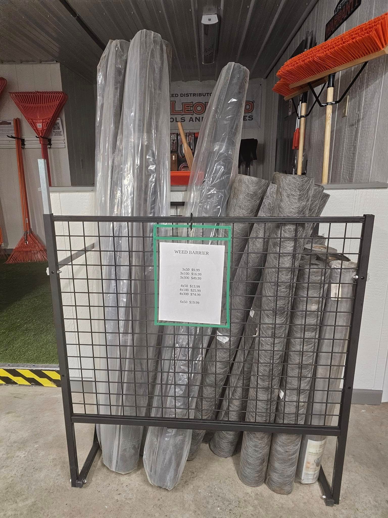 Stacked insulated pipes in a metal rack inside an industrial storage area.