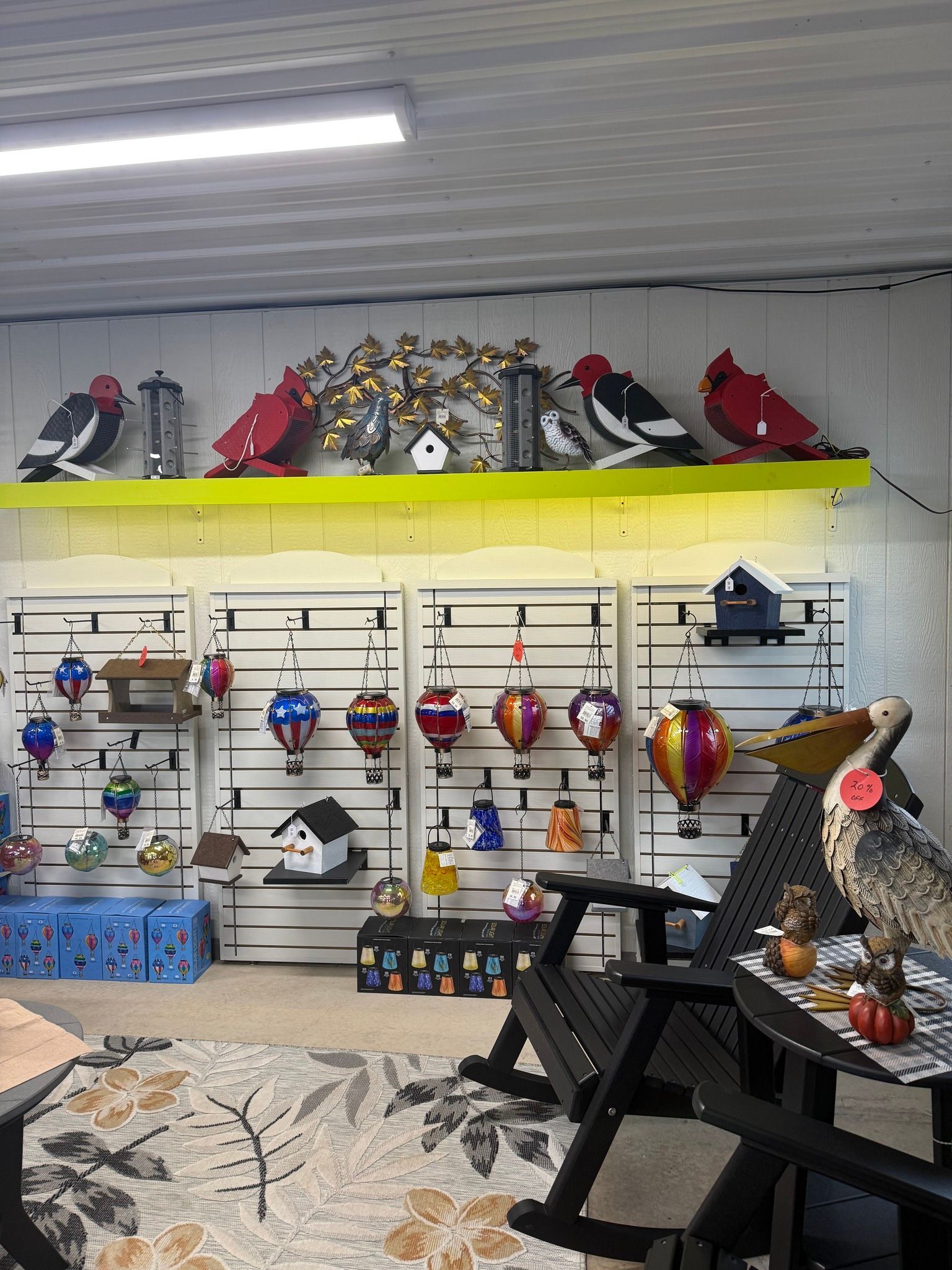 Shelves of colorful decorative birdhouses and bird figurines in a shop display