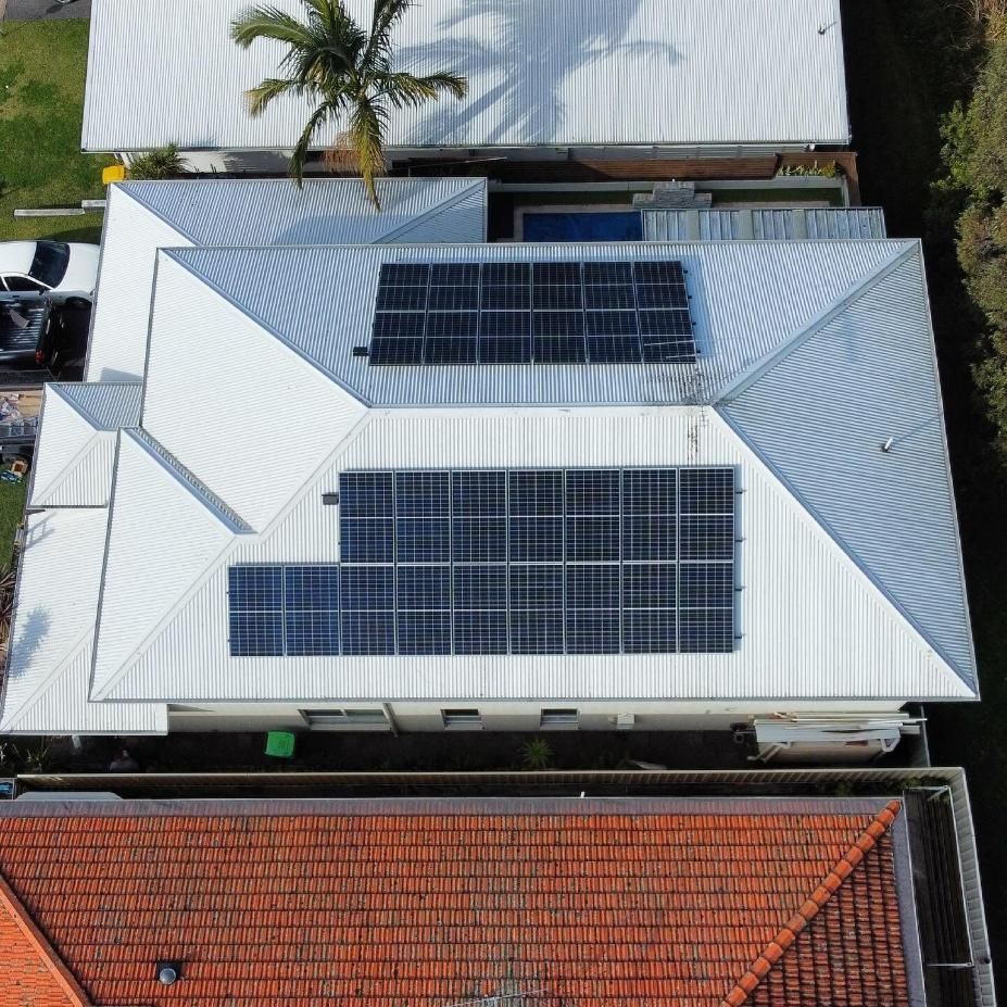 An Aerial View of A House with Solar Panels on The Roof — Podium Solar in Cameron Park, NSW