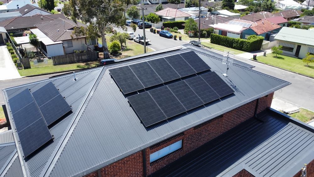 An Aerial View of A House with Solar Panels on The Roof — Podium Solar in Cameron Park, NSW