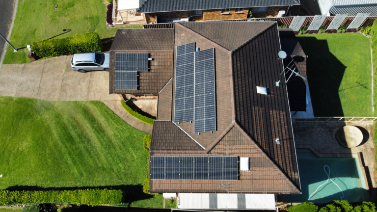 An Aerial View of A House with Solar Panels on The Roof — Podium Solar in Toronto, NSW