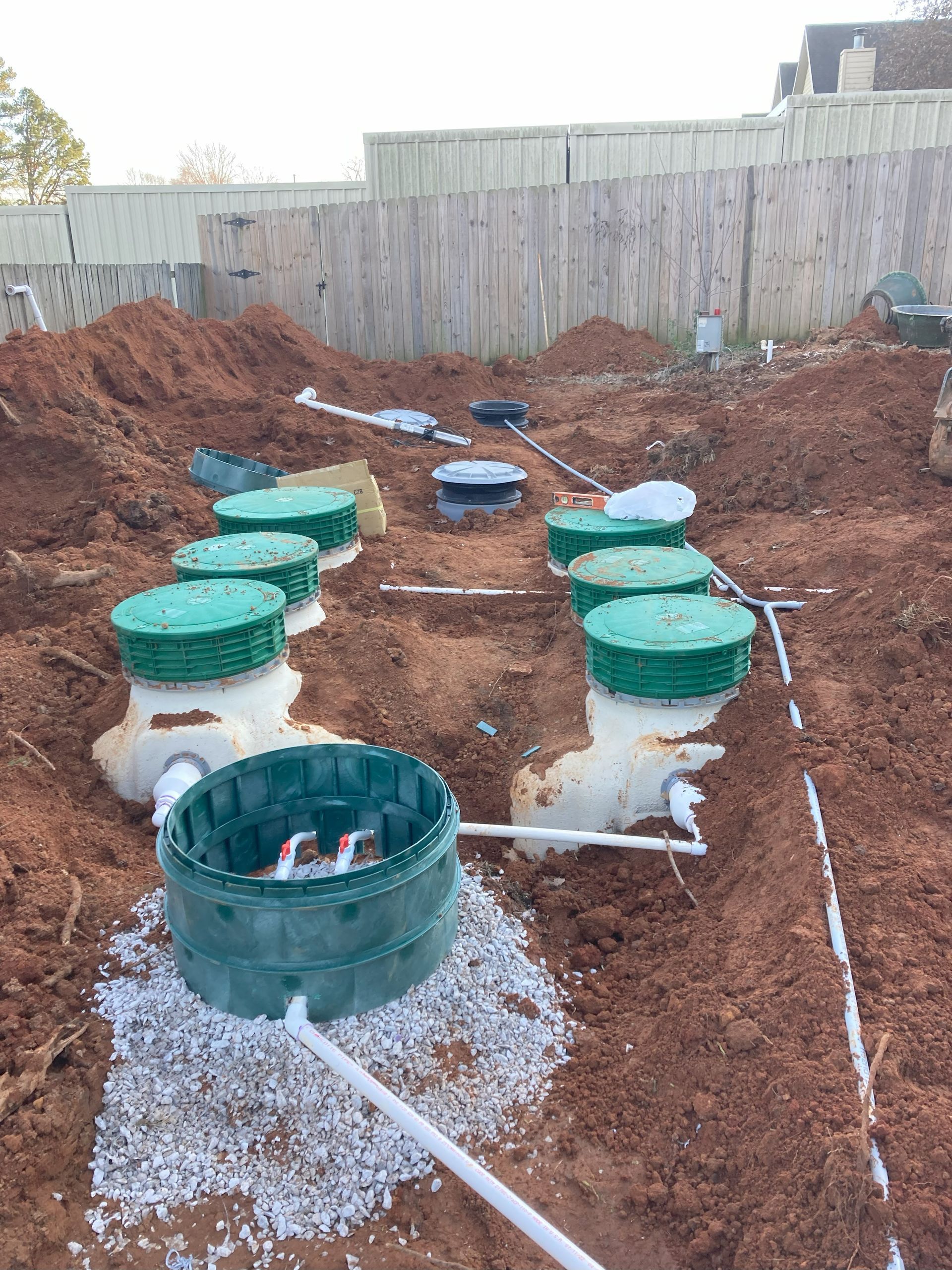 A septic system is being installed in a backyard.