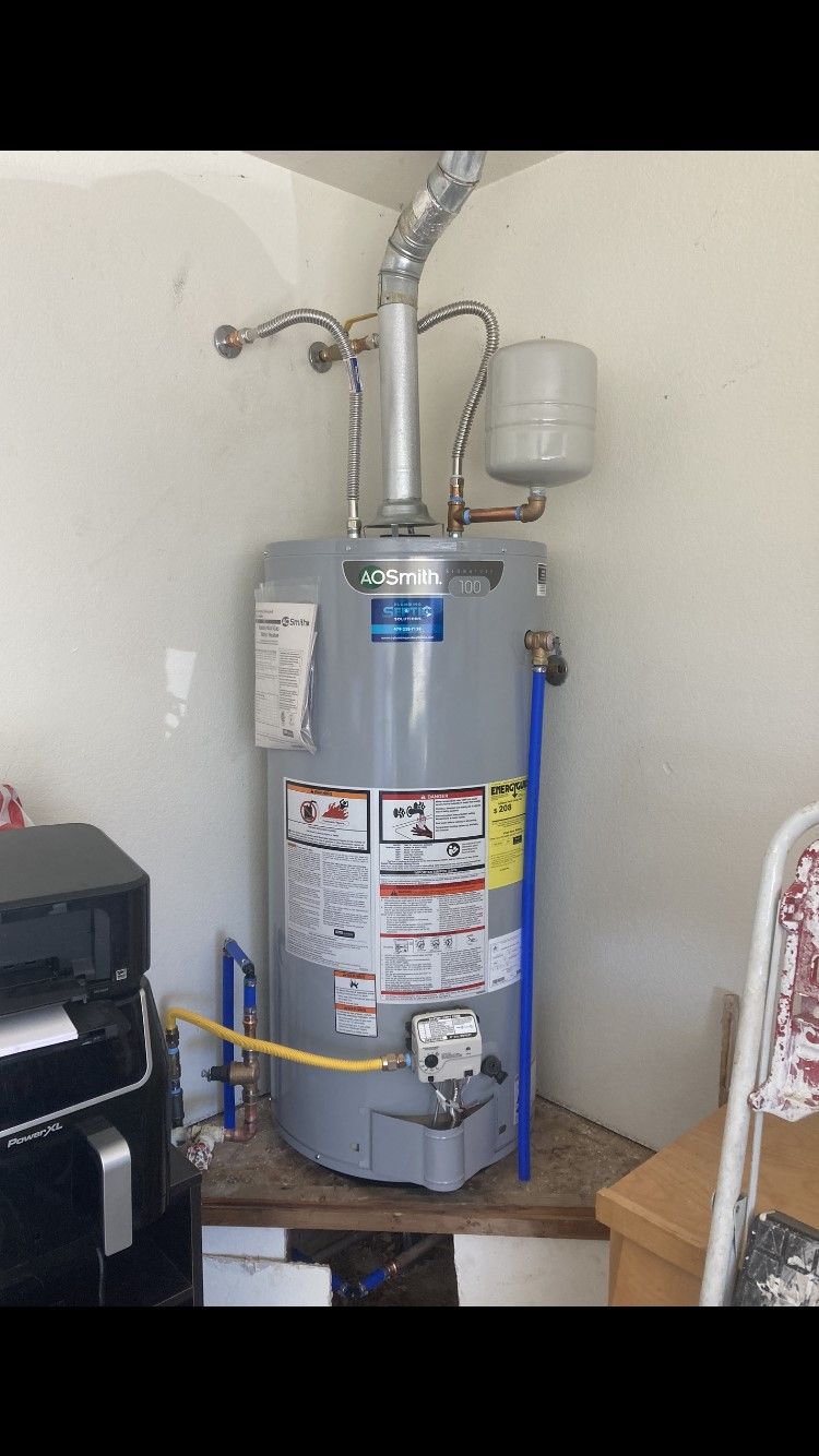 A water heater is sitting on a wooden table in a room.