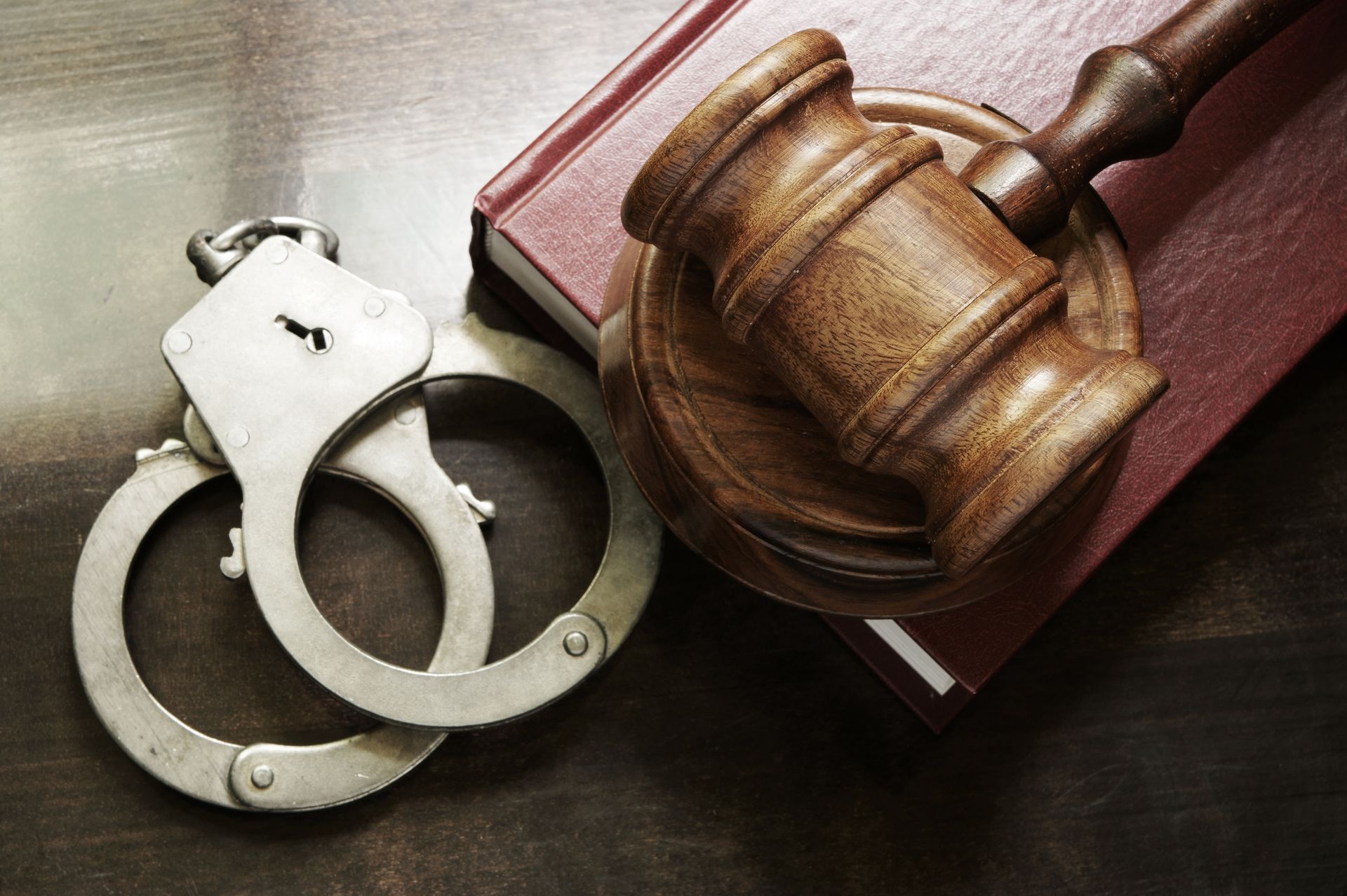 Judge’s gavel on a black base over scattered dollar bills and a pen, symbolizing law and money Judge’s gavel on a black base over scattered dollar bills and a pen, symbolizing law and money