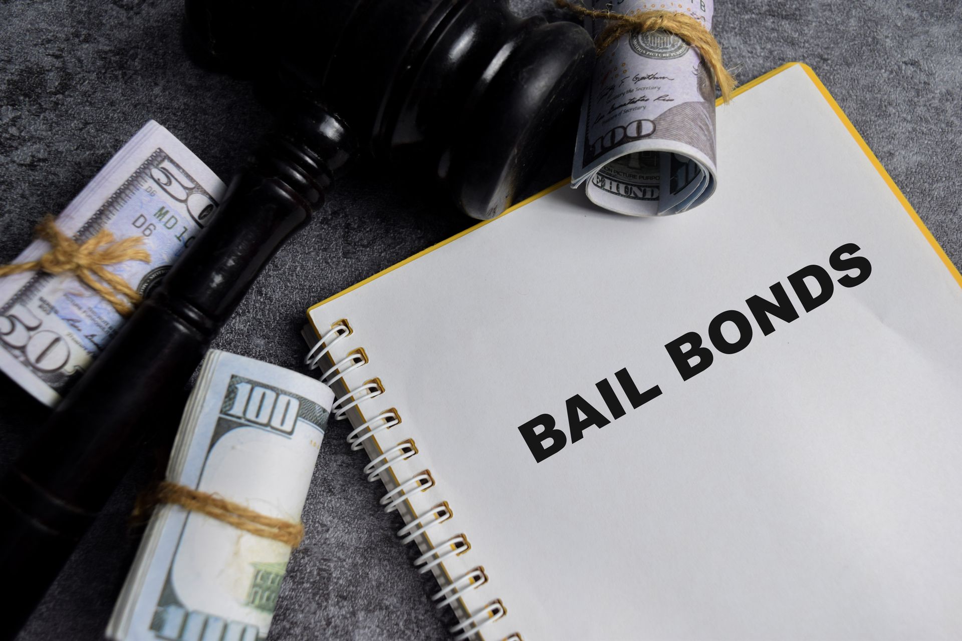 A gavel, money rolls, and a notebook with A gavel, money rolls, and a notebook with