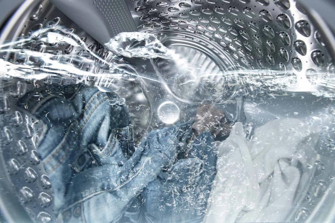 A Washing Machine Filled With Water and Clothes Are Being Washed — A.S.A.P. Appliance Service & Sales in Hamlyn Terrace, NSW