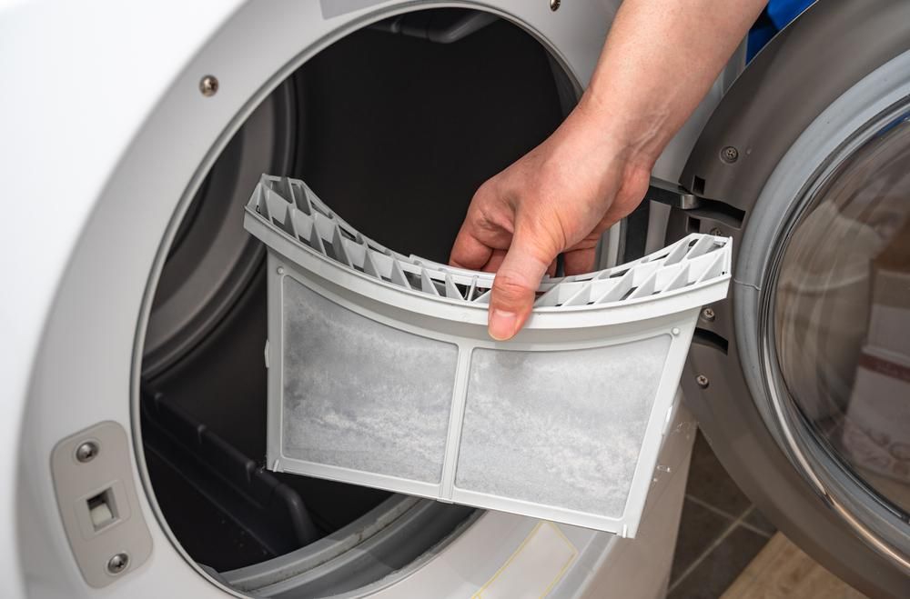 Hand Holding Dryer Lint Filter — A.S.A.P. Appliance Service & Sales in Budgewoi, NSW