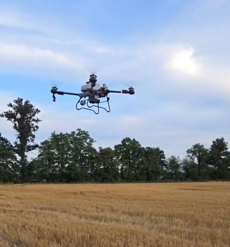 Drone flying over a field after harvest