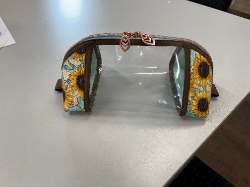 A Clear Cosmetic Bag With Sunflowers on It is Sitting on a Table— Lyn-Jelle Crafts in Emu Park, QLD