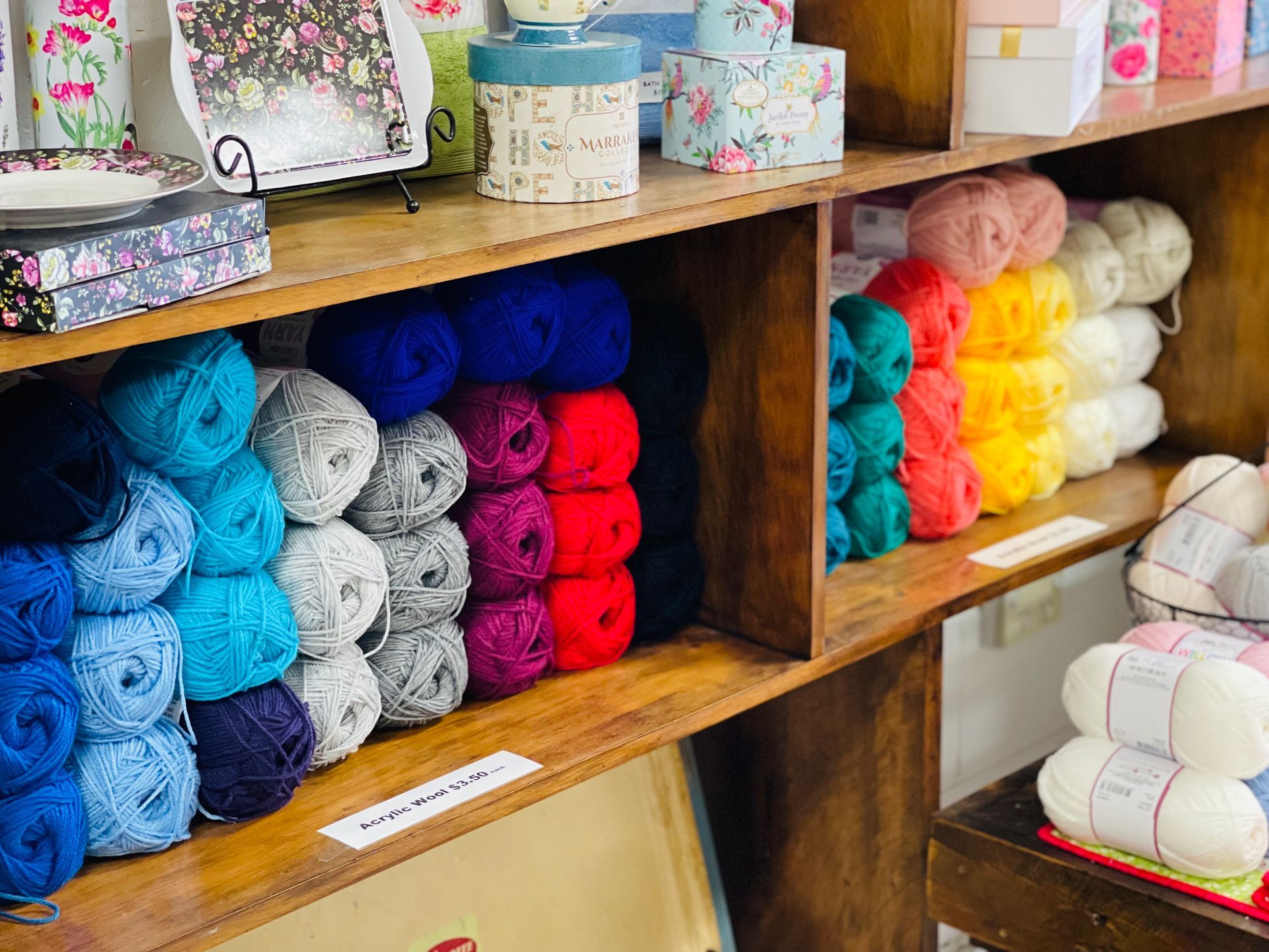 A Shelf Filled With Balls of Yarn of Different Colors — Lyn-Jelle Crafts in Emu Park, QLD