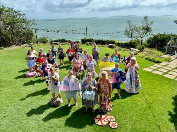 A Group of People Are Posing for a Picture on a Lush Green Field — Lyn-Jelle Crafts in Emu Park, QLD