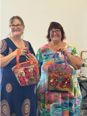 Two Women Standing Next to Each Other Holding Handbags — Lyn-Jelle Crafts in Emu Park, QLD