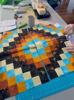 A Person is Cutting a Piece of Fabric on a Cutting Mat — Lyn-Jelle Crafts in Emu Park, QLD