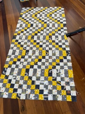 A Yellow and Black Checkered Table Cloth on a Wooden Floor — Lyn-Jelle Crafts in Emu Park, QLD