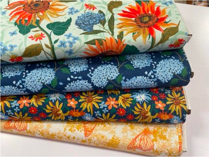 Four Pieces of Fabric With Flowers on Them Are Stacked on Top of Each Other — Lyn-Jelle Crafts in Emu Park, QLD