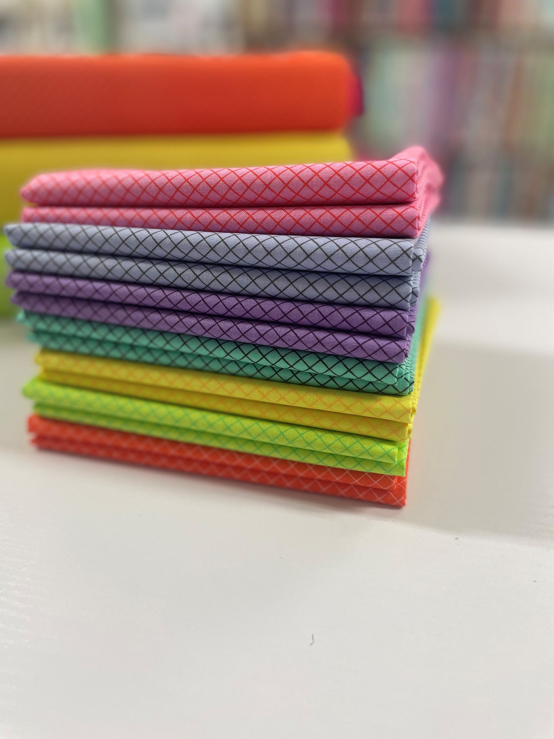 Stack of Colorful Fabric Squares With a Crisscross Pattern — Lyn-Jelle Crafts in Emu Park, QLD