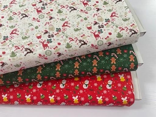 Three Pieces of Christmas Fabric Are Stacked on Top of Each Other on a Table — Lyn-Jelle Crafts in Emu Park, QLD