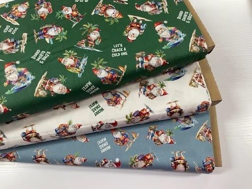 Three Pieces of Fabric With Santa Clauses on Them Are Stacked on Top of Each Other — Lyn-Jelle Crafts in Emu Park, QLD