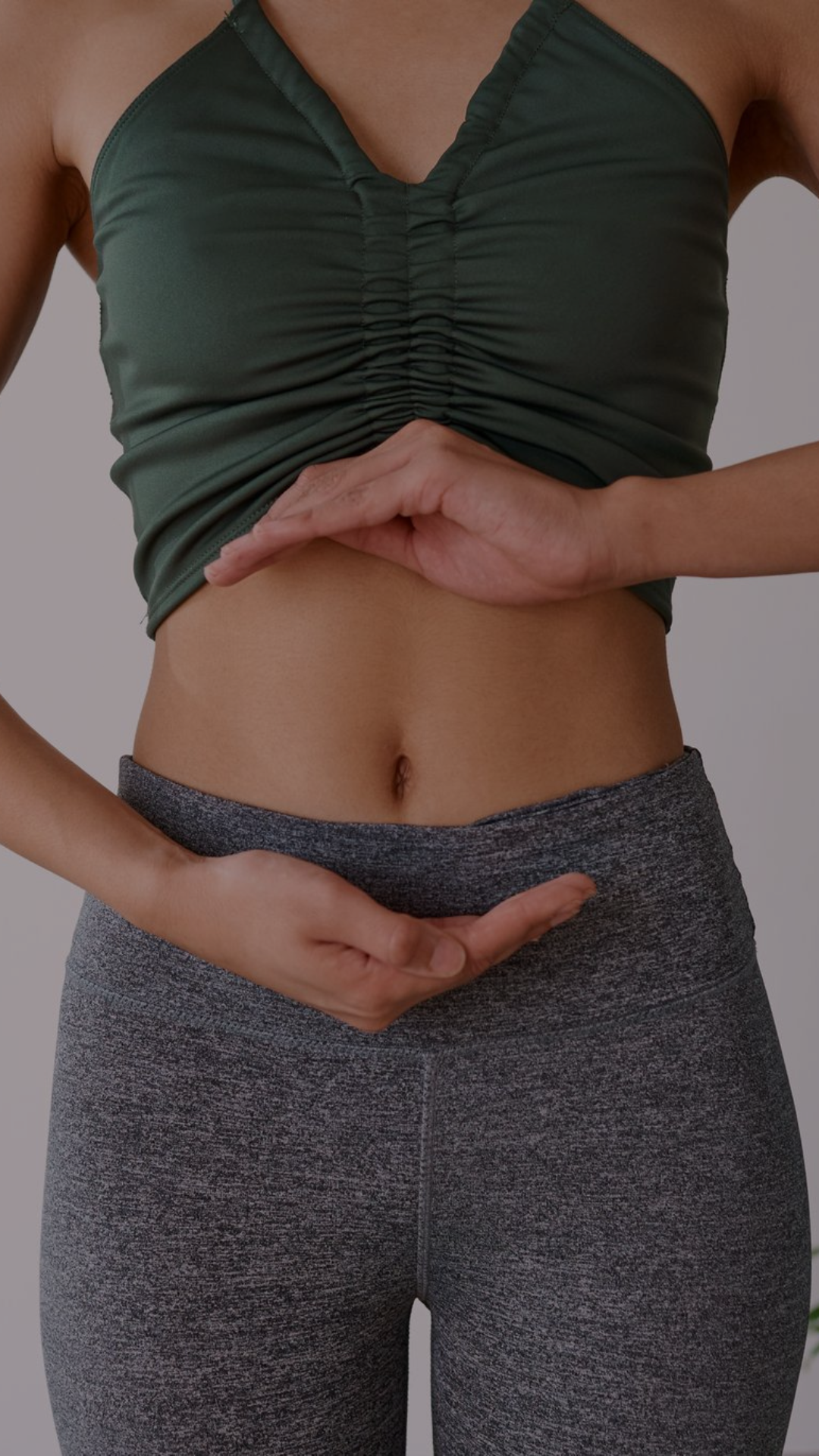 woman with hands around stomach