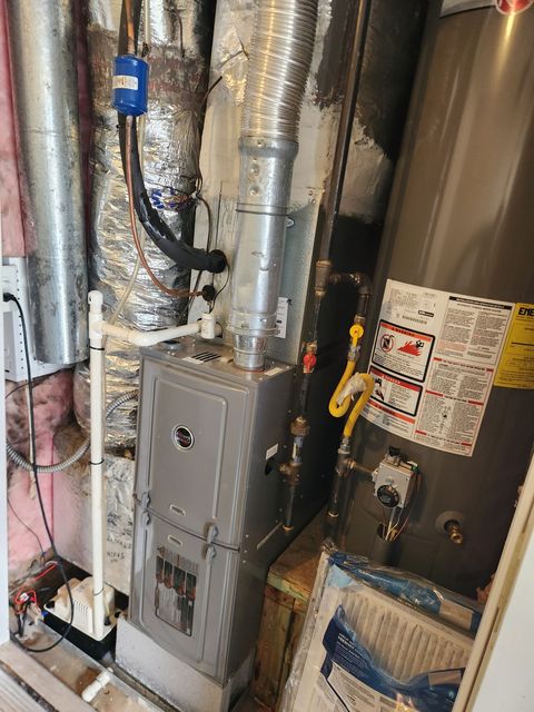 Residential utility room with HVAC/furnace equipment, ducts, pipes, and exposed insulation.