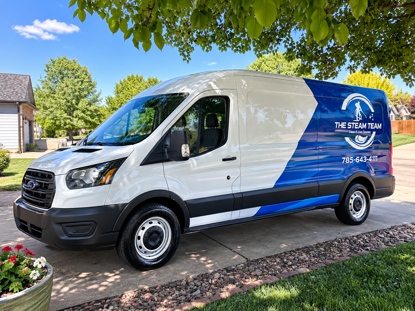 White and blue service van parked on a suburban street under trees