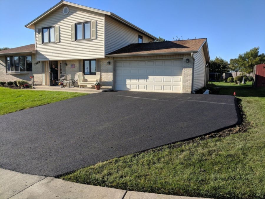 Asphalt driveway with expanded parking for a commercial property near Lake Street in Addison.