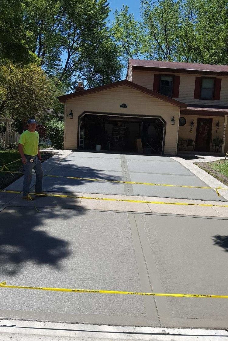 Ty the owner from TMW Enterprises standing on a completed paving project in Addison, IL.