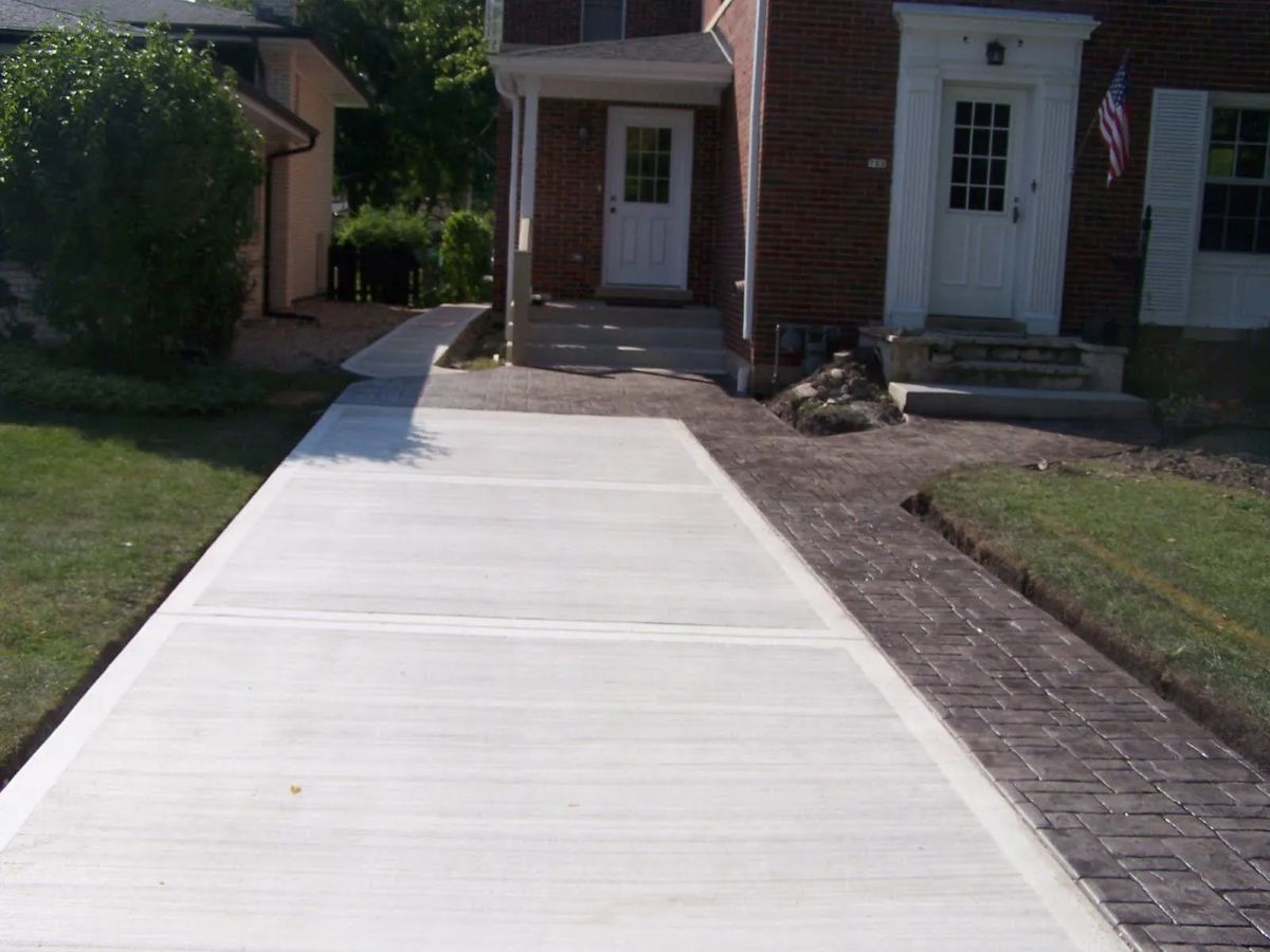 New concrete driveway installation with a stamped concrete walkway for a home in Arlington Heights, IL.
