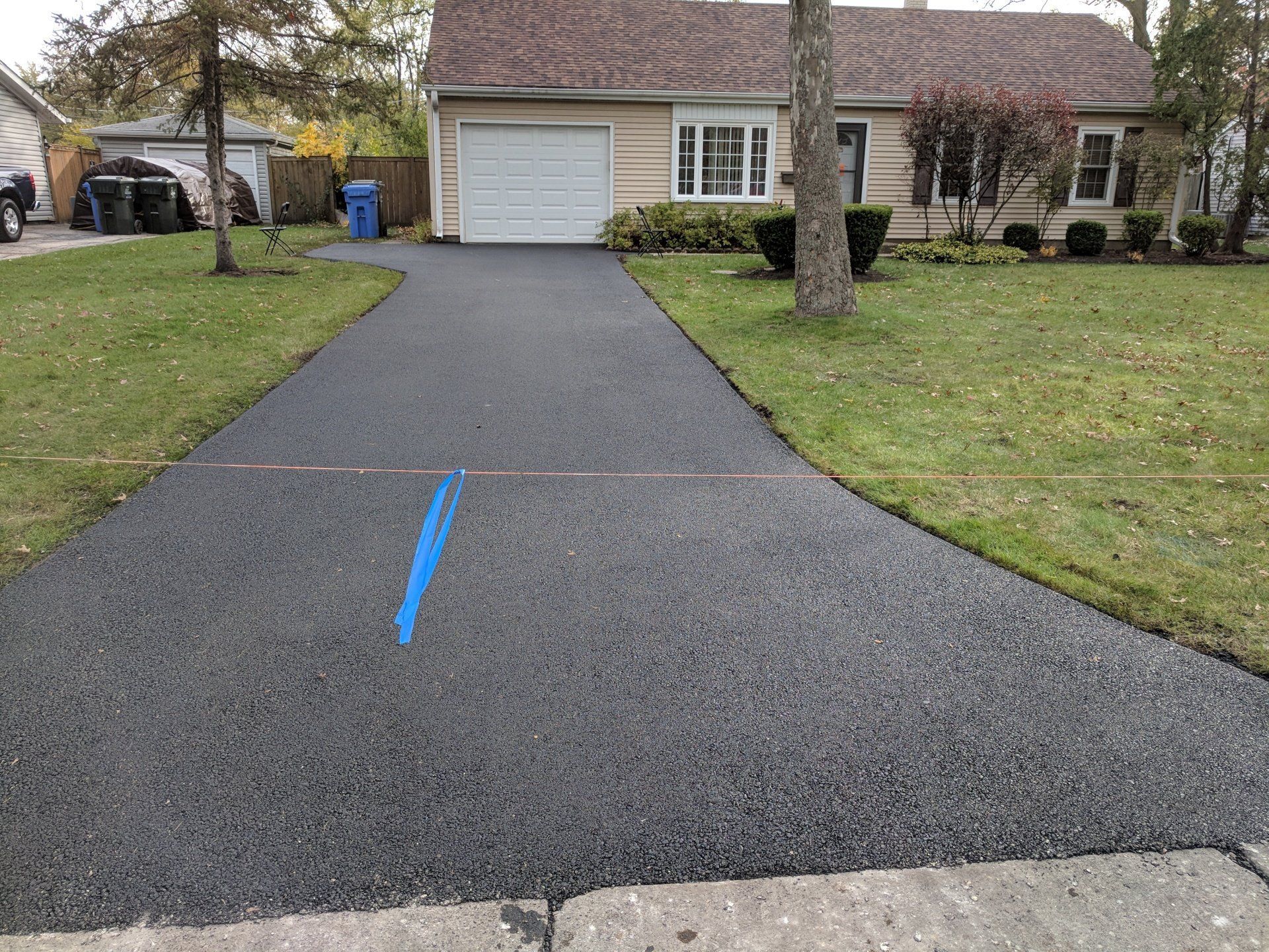 Newly paved asphalt driveway with clean edges in Main Township - Des Plaines, IL.