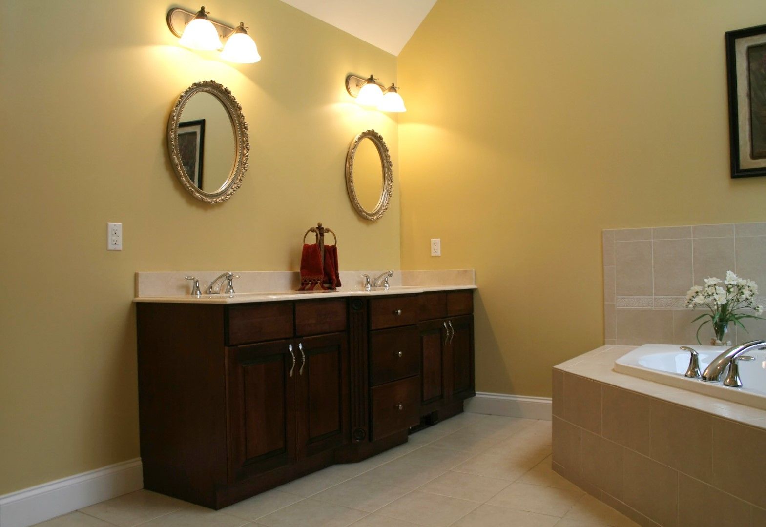 A picture with sink on left side bathroom vanities and yellow walls in a remodeled bathroom in Bonney Lake bathroom Remodeling. 