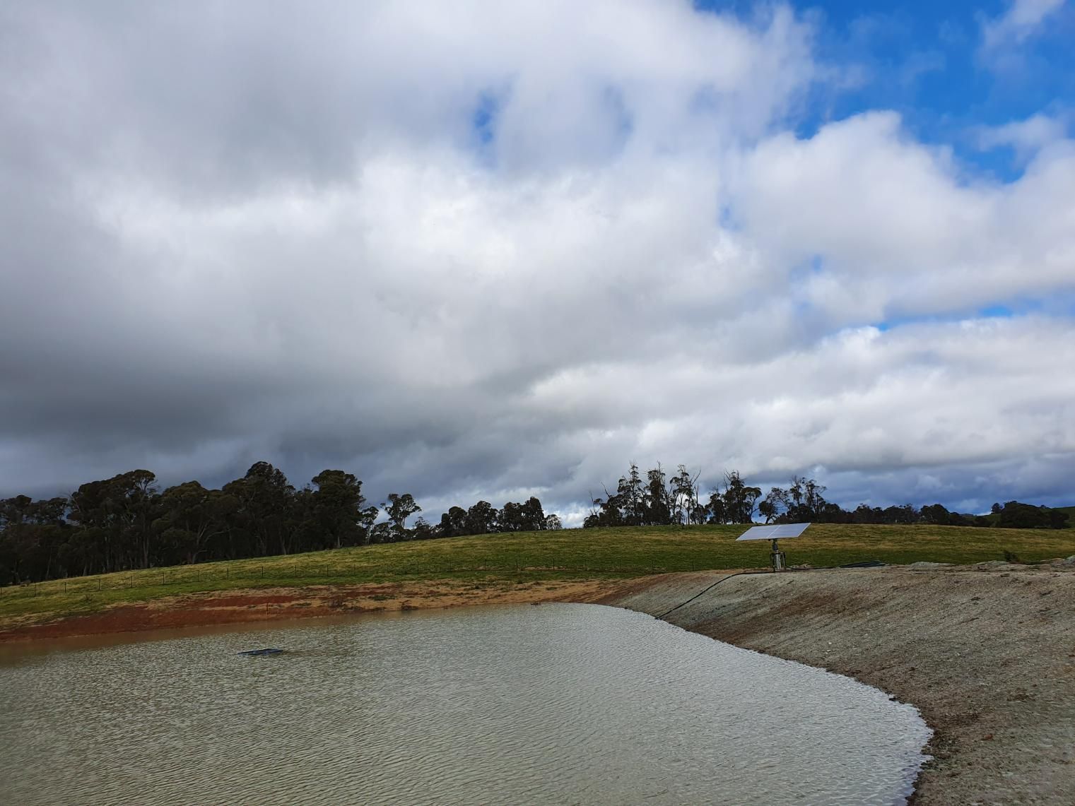 Cloudy Sky Over a Dirt Road With Trees — Peel Irrigation & Water Supplies in Walcha, NSW