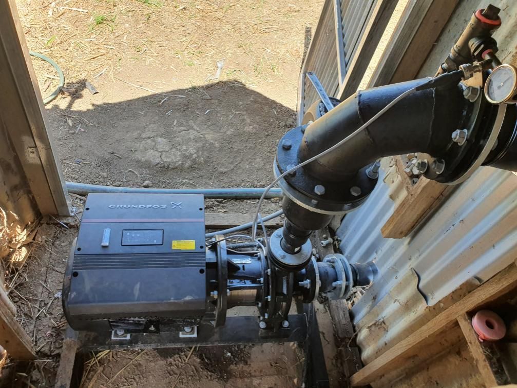 A Black Pipe Is Connected to A Black Box in A Room — Peel Irrigation & Water Supplies in Taminda, NSW