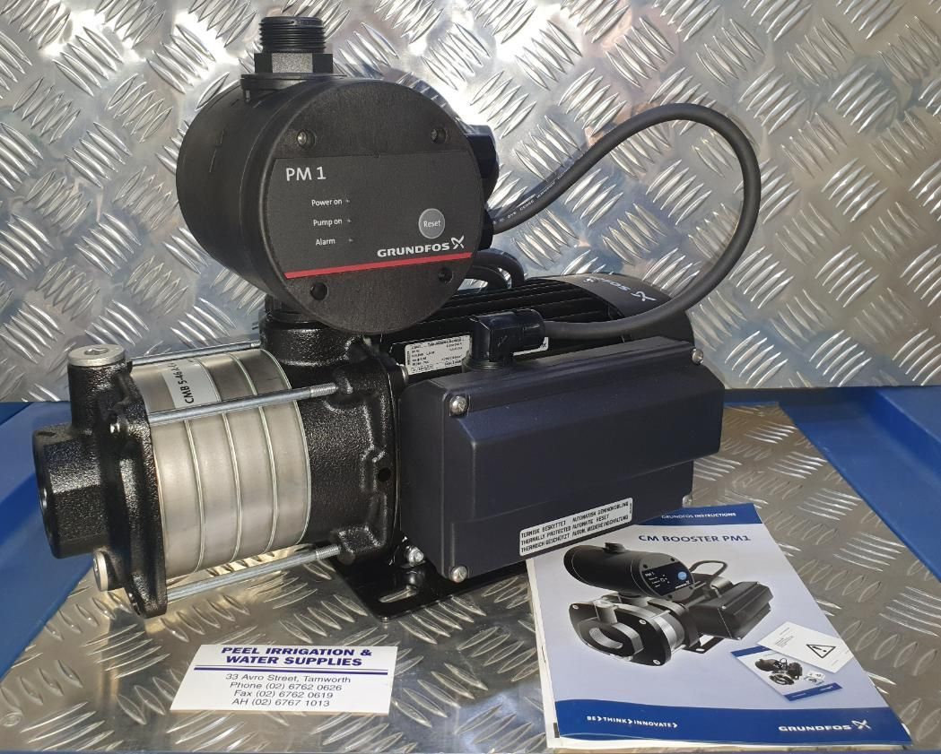 A Water Pump Sits on A Metal Surface Next to A Manual — Peel Irrigation & Water Supplies in Taminda, NSW