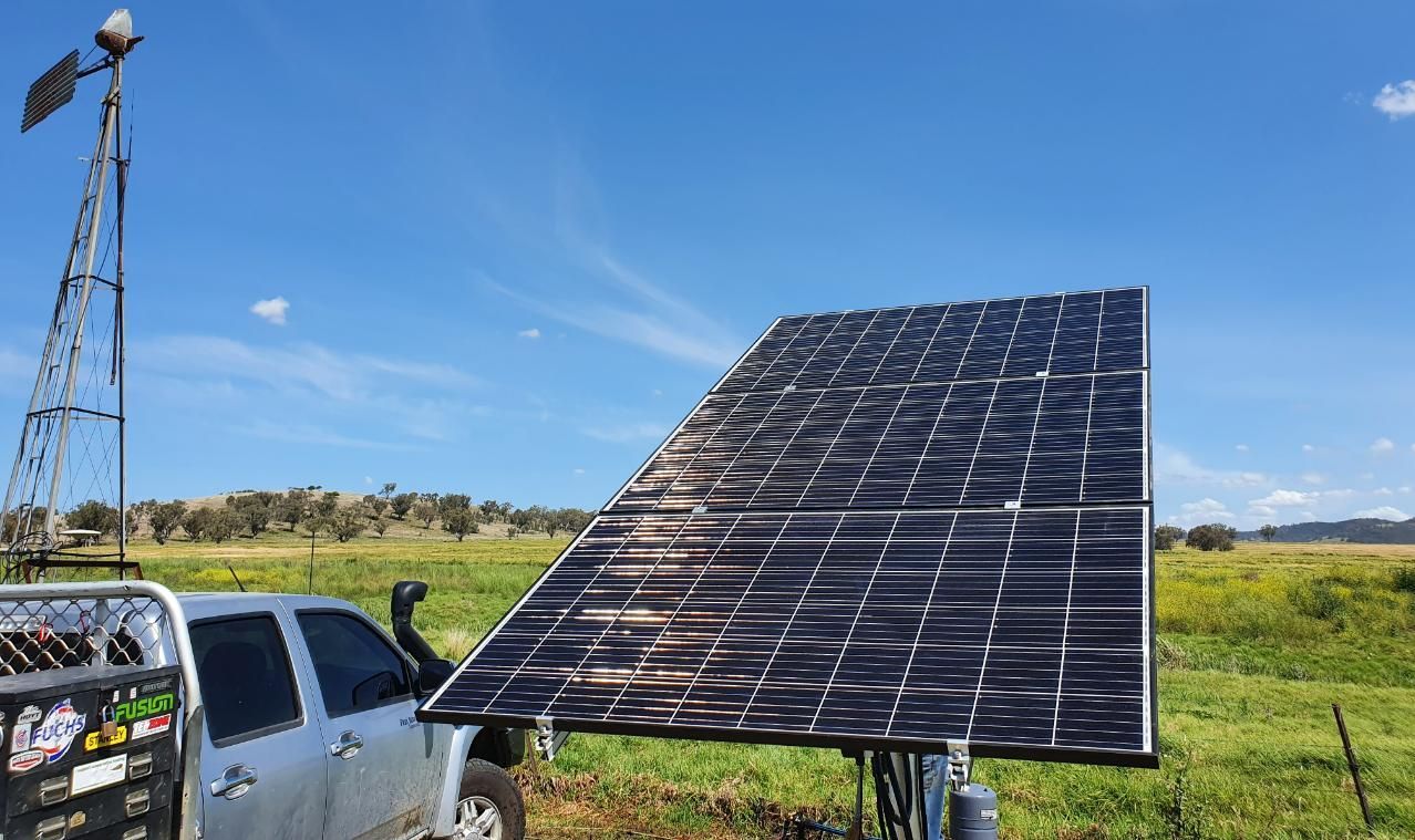 A Truck Is Parked Next to A Solar Panel in A Field — Peel Irrigation & Water Supplies in Taminda, NSW