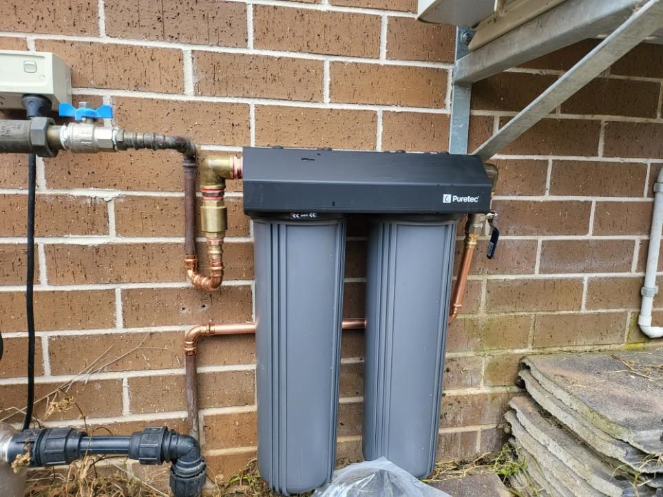 A Water Filter Is Attached to A Brick Wall — Peel Irrigation & Water Supplies in Taminda, NSW