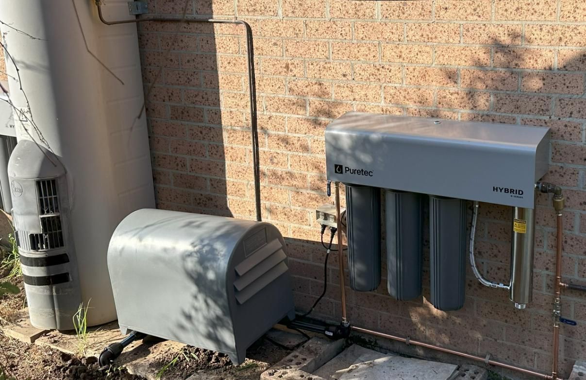 A Gray Box Is Sitting Next to A Brick Wall — Peel Irrigation & Water Supplies in Taminda, NSW