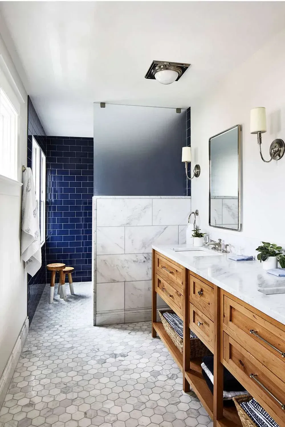 Detail of modern bathroom vanity with double sinks, custom wooden joinery, and marble counter for a 7-Year Guaranteed Newcastle bathroom renovation.