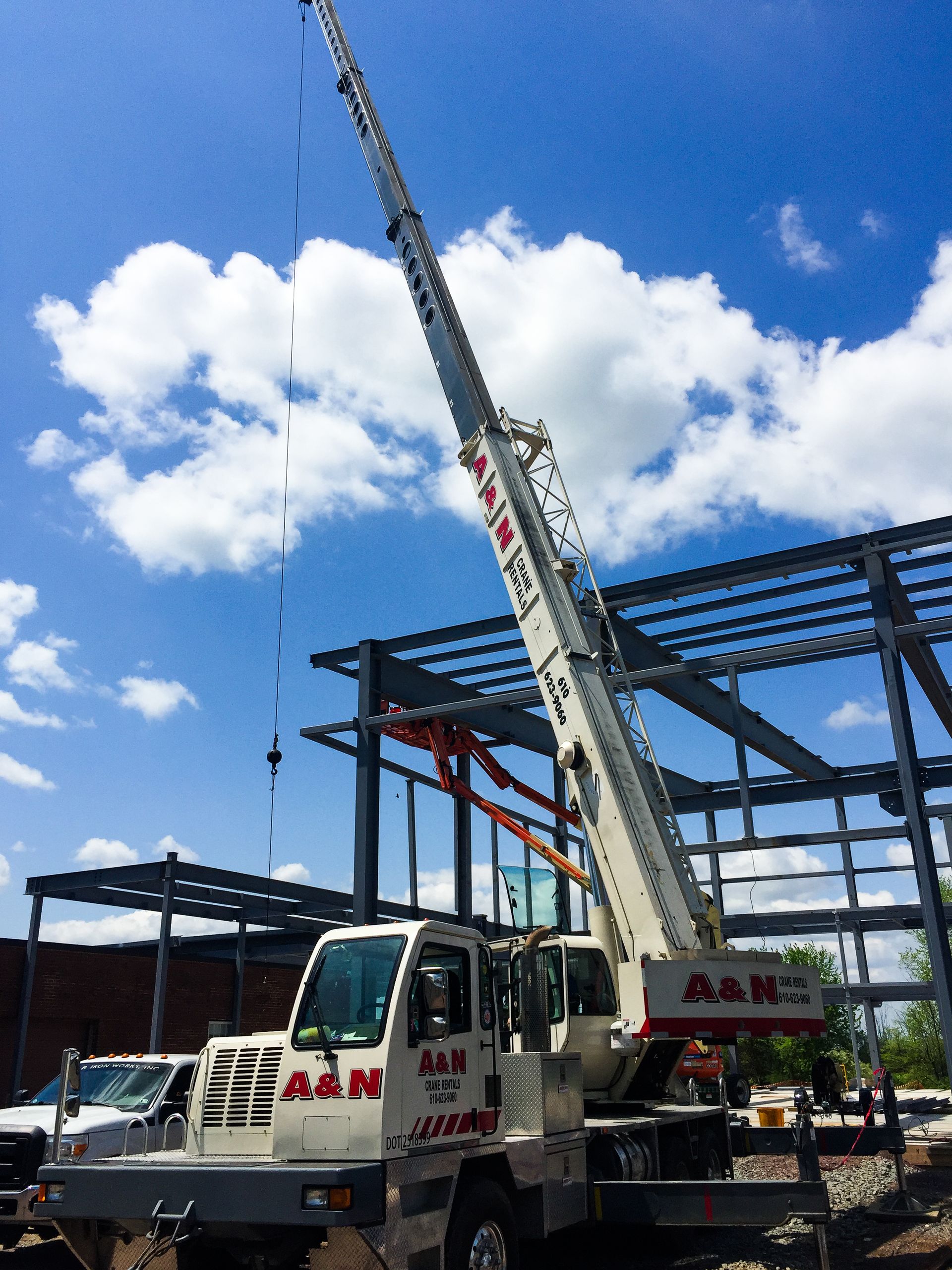 A white crane from A&N Crane Rental is completing a steel erection project.