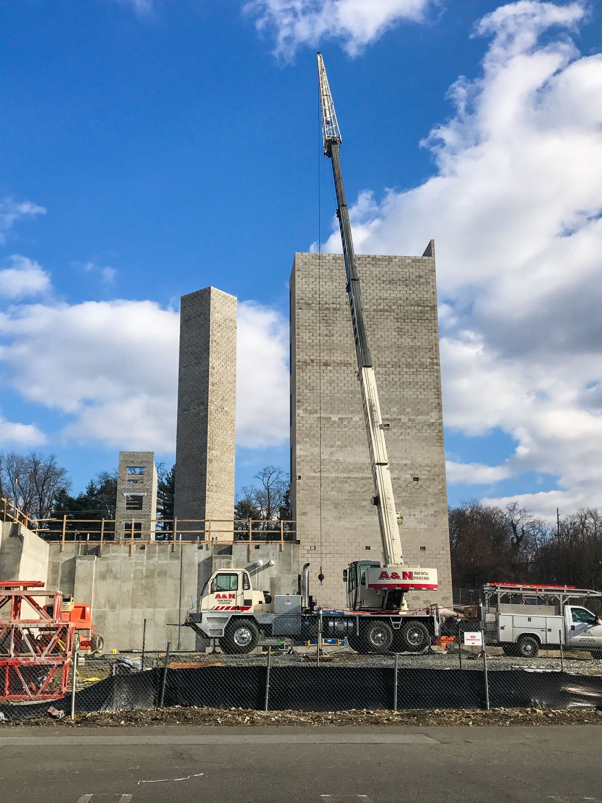 A large concrete structure is being built with a crane from A&N Crane Rental in the foreground.