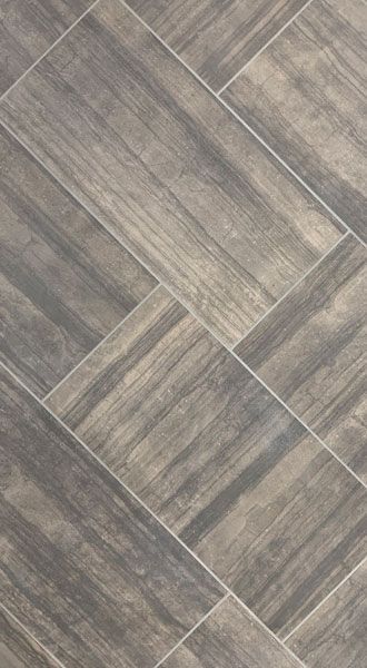 A close up of a tile floor that looks like wood.