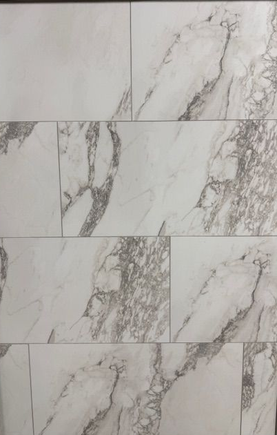 A close up of a gray tile floor that looks like wood.