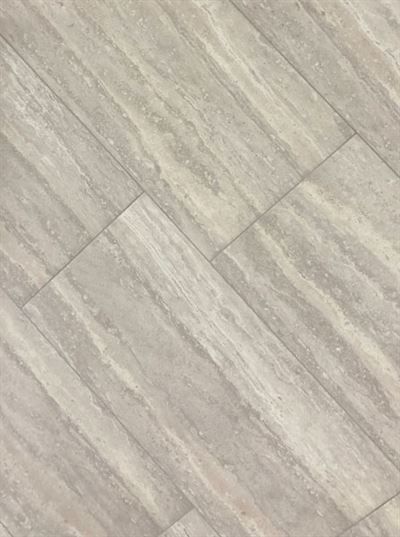 A close up of a tile floor that looks like wood.